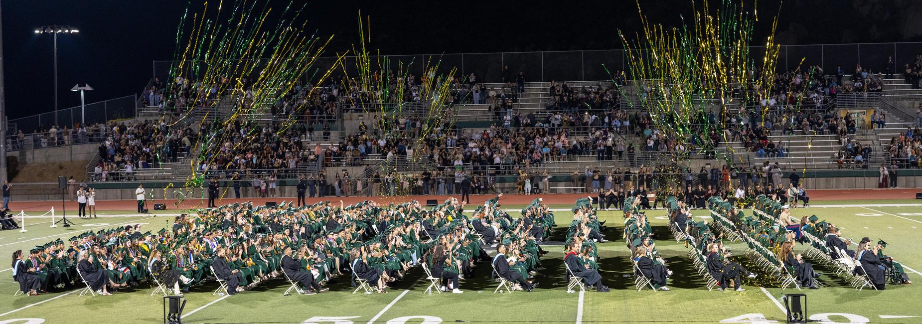 tahquitz high school graduates sittin gon football field
