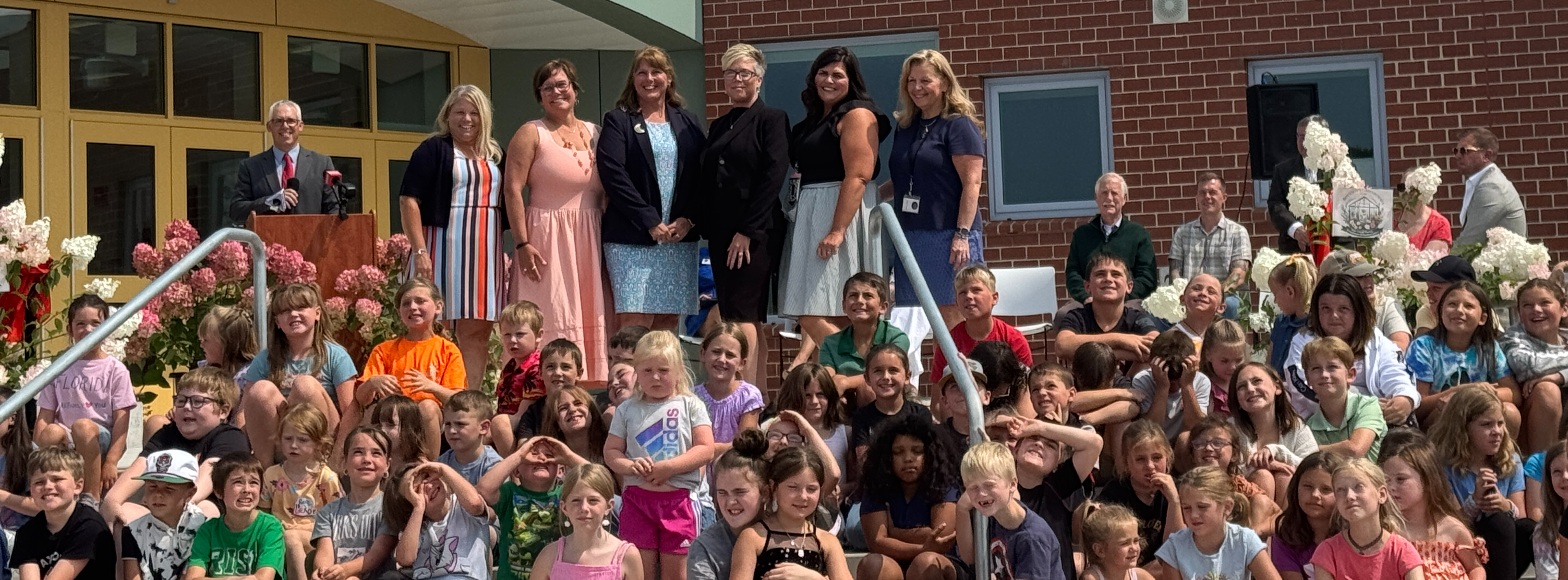 Students and staff on the front steps of the Margaret Chase Smith Community School