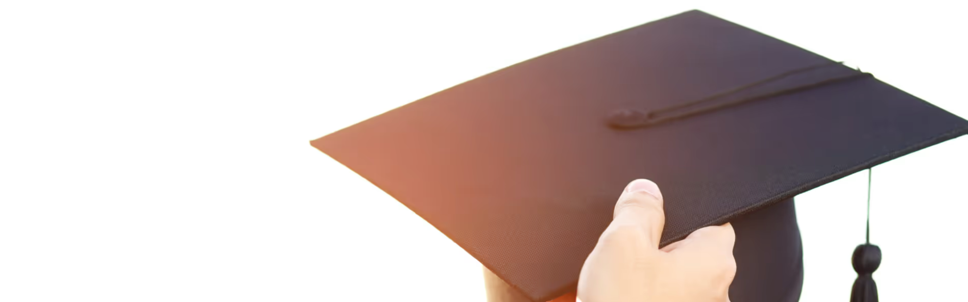 silhouette of grads throwing their caps up in the air