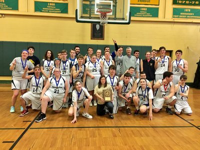 A photo of the basketball team with an award