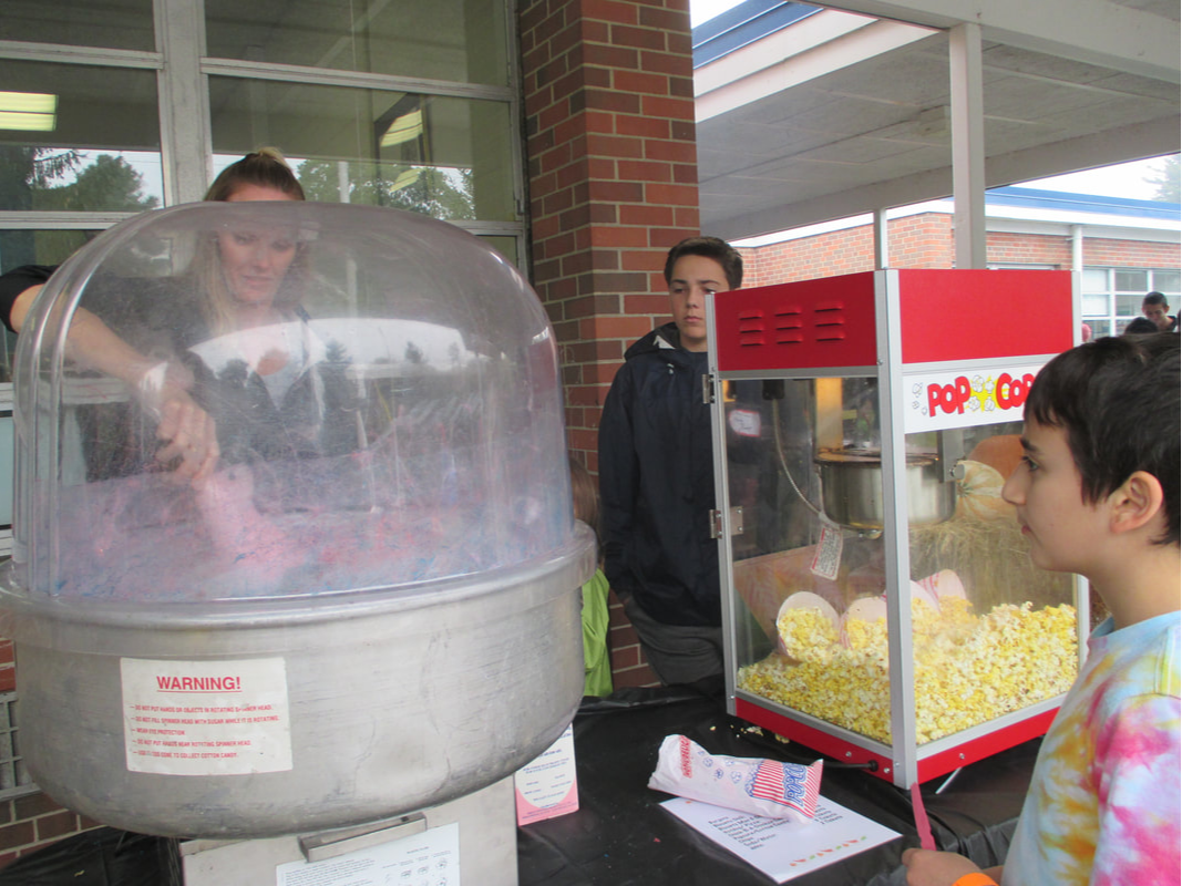 A photo of a student getting some cotton candy at an Interact Club event