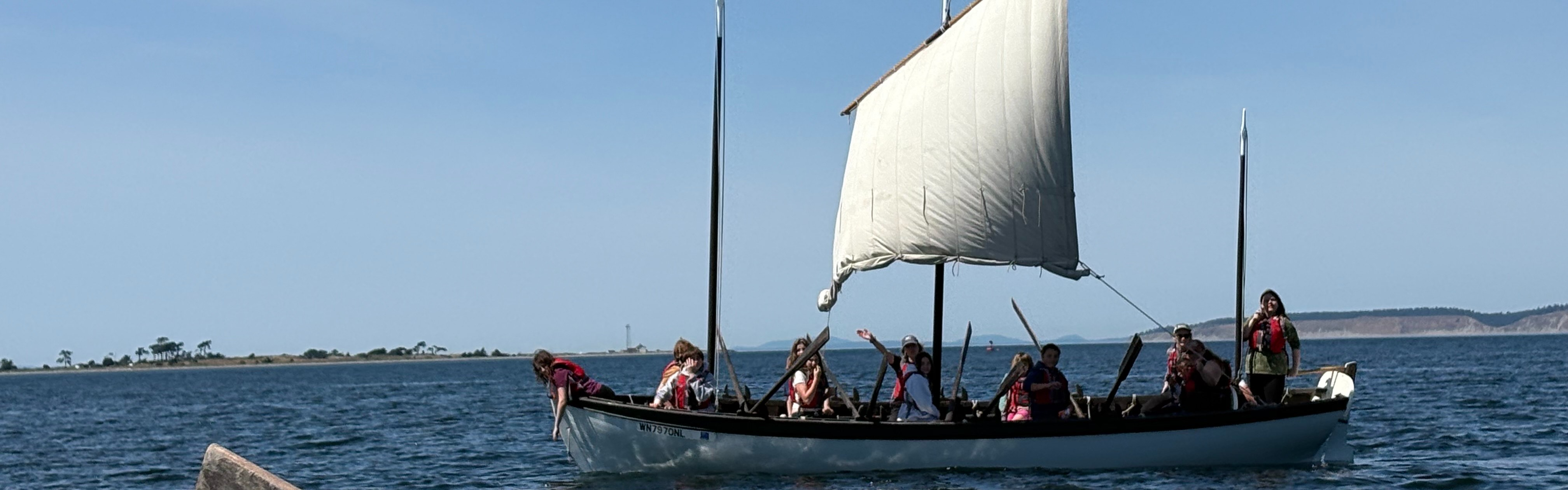 students on a long boat
