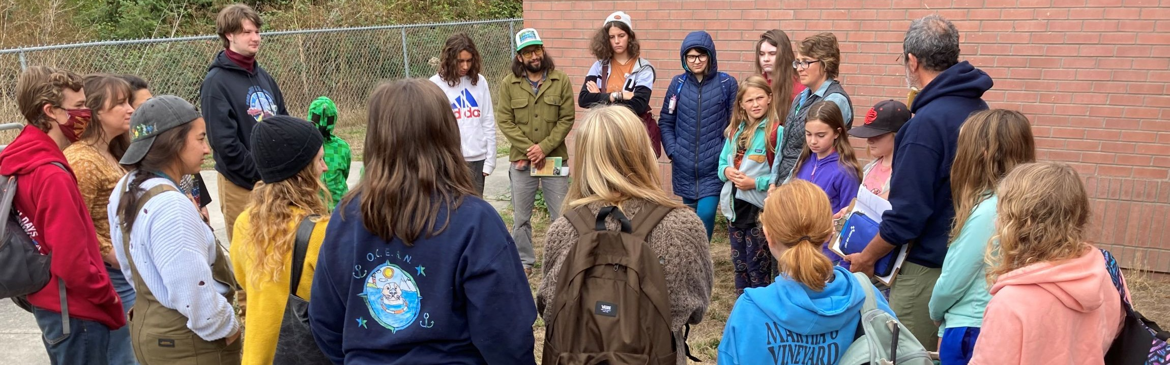 students and teachers in a circle