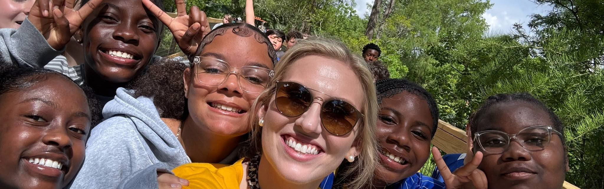Students and teacher taking selfie on a field trip