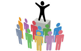 A graphic of a person standing on a podium in front of a crowd