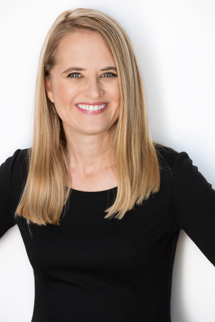 1. A woman with blonde hair wearing a black top, looking confidently at the camera. 2. A woman with blonde hair dressed in a black top, smiling softly while standing outdoors. 3. A woman with blonde hair in a black top, posing against a neutral background.