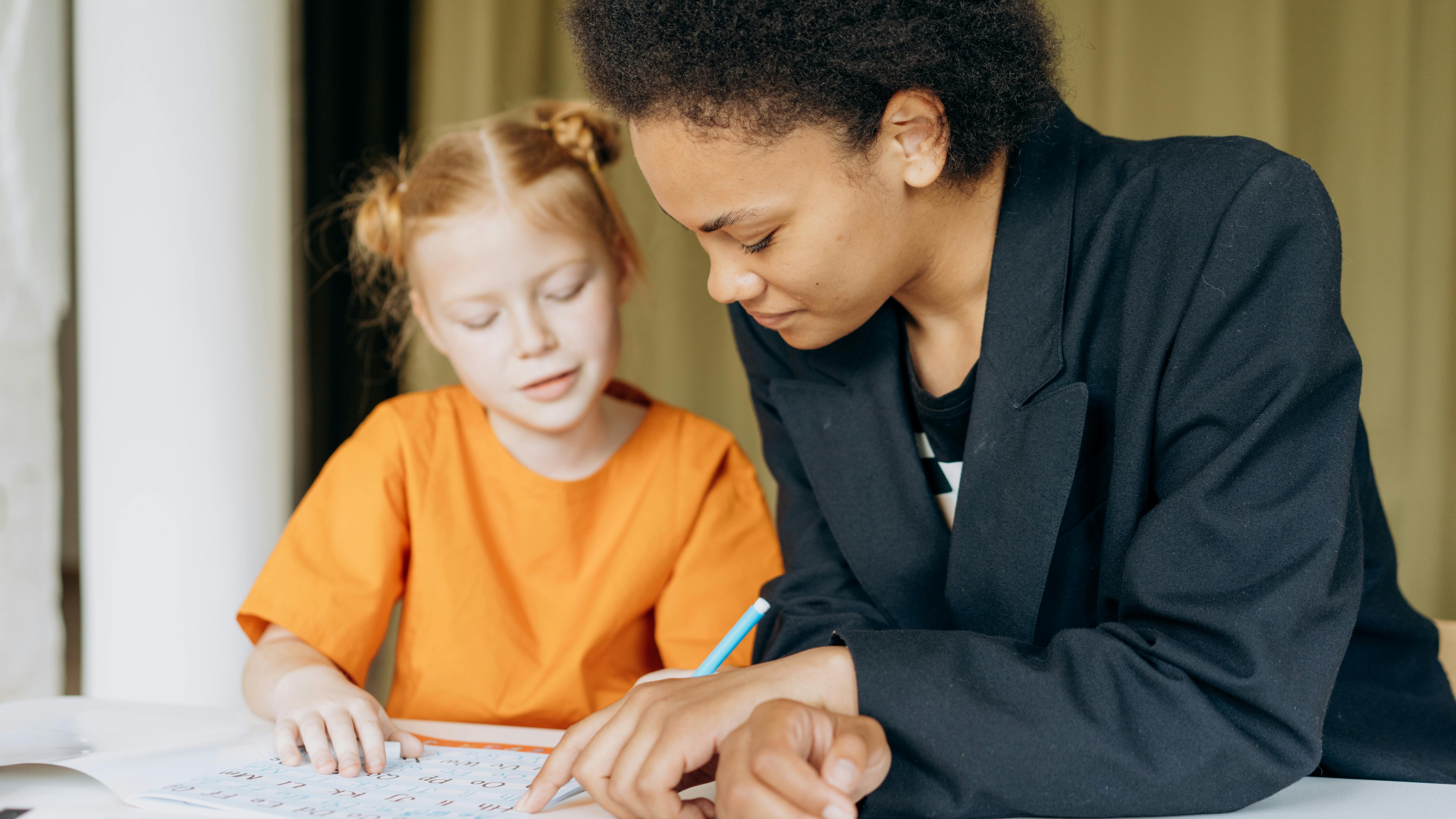 Teacher teaching a student how to read