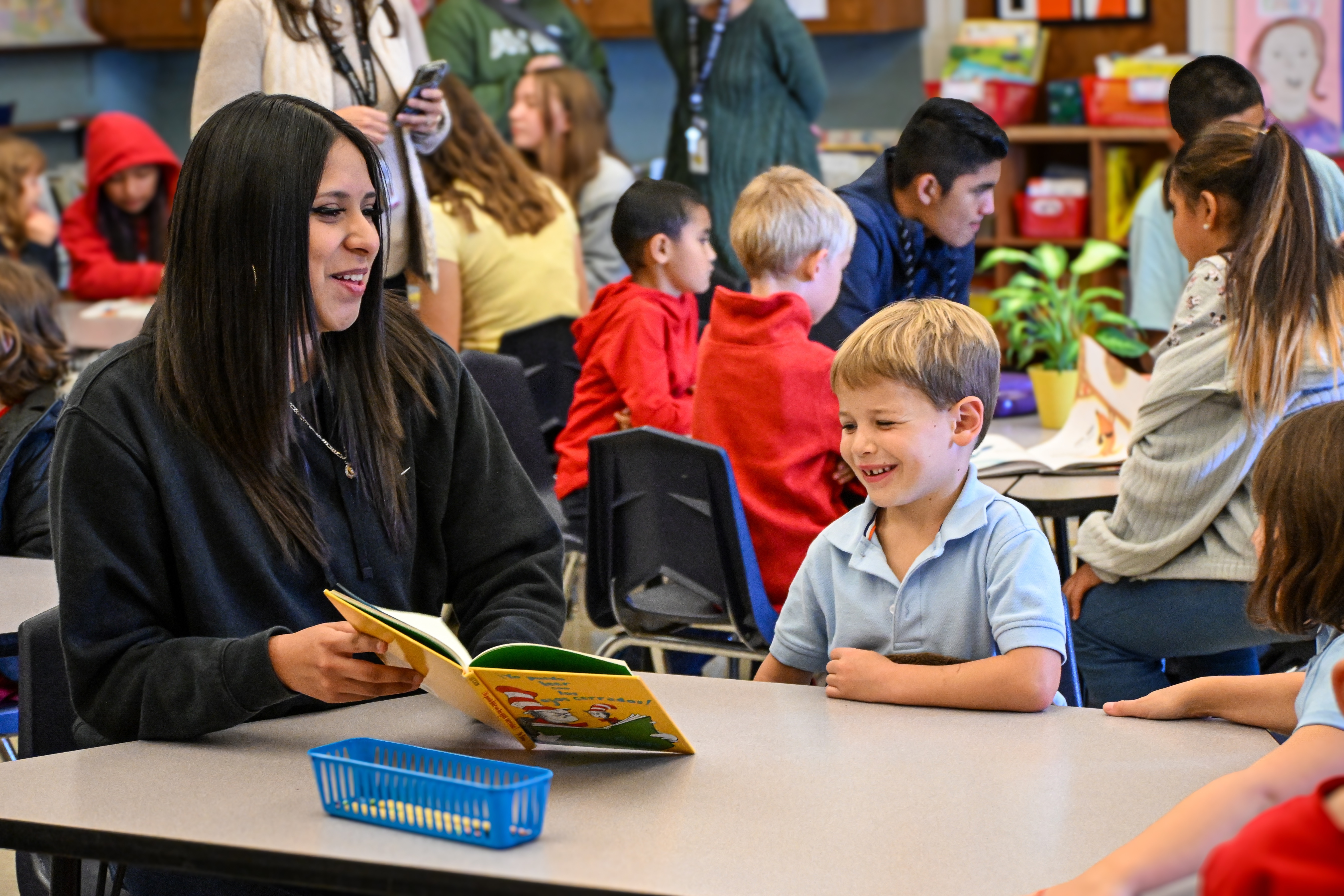 Older student reading to younger student