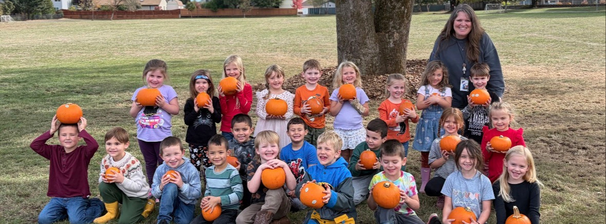 Kids holding pumpkins