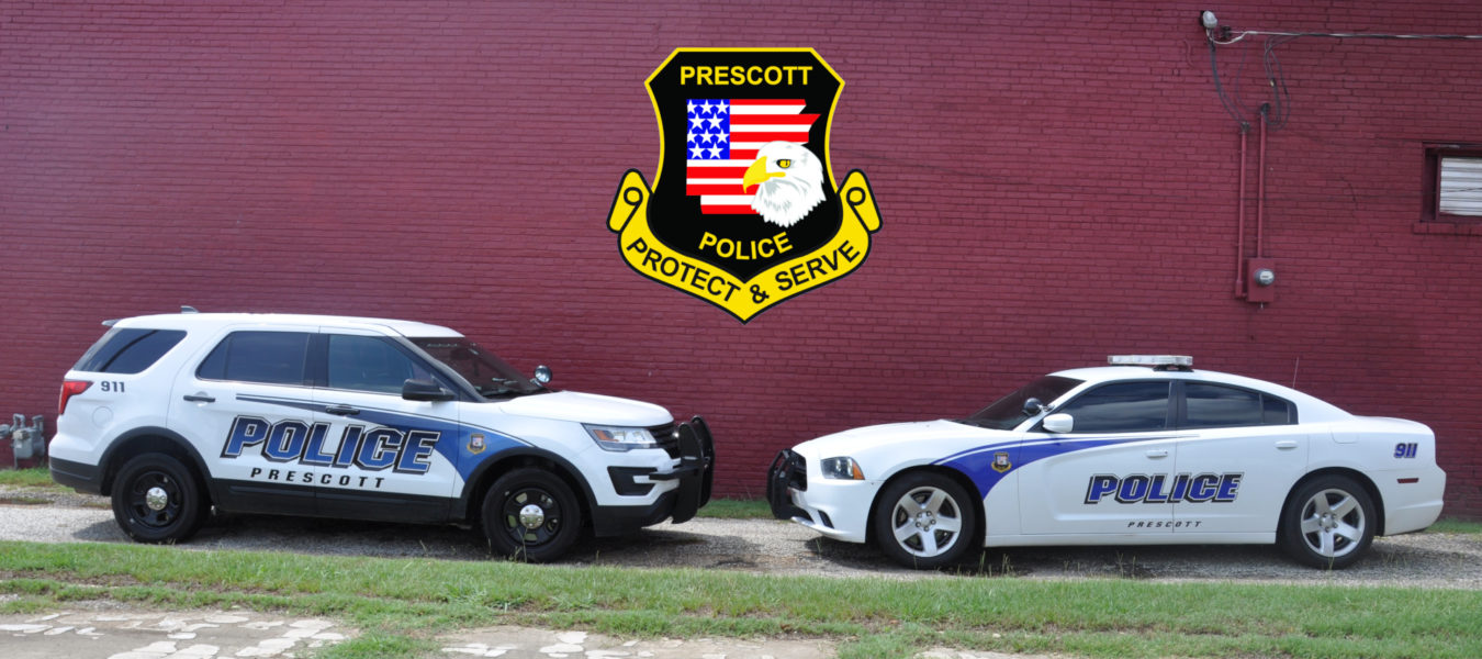 two police cars pointed to each other with the Prescott police logo in the middle