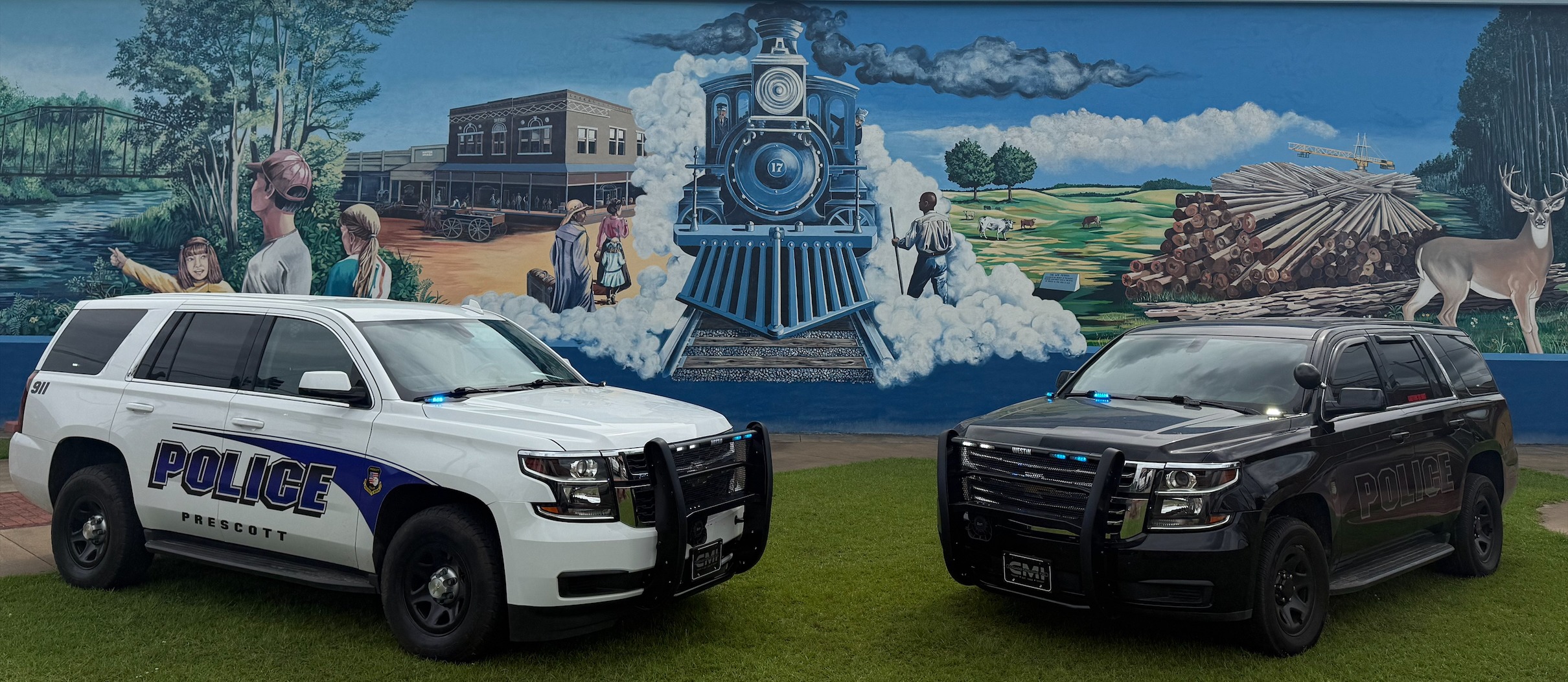 two police cars pointed to each other with the Prescott police logo in the middle