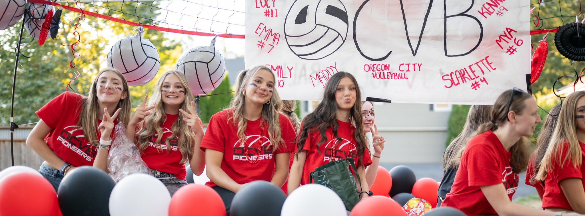 Girls Volleyball team on parade float with balloons