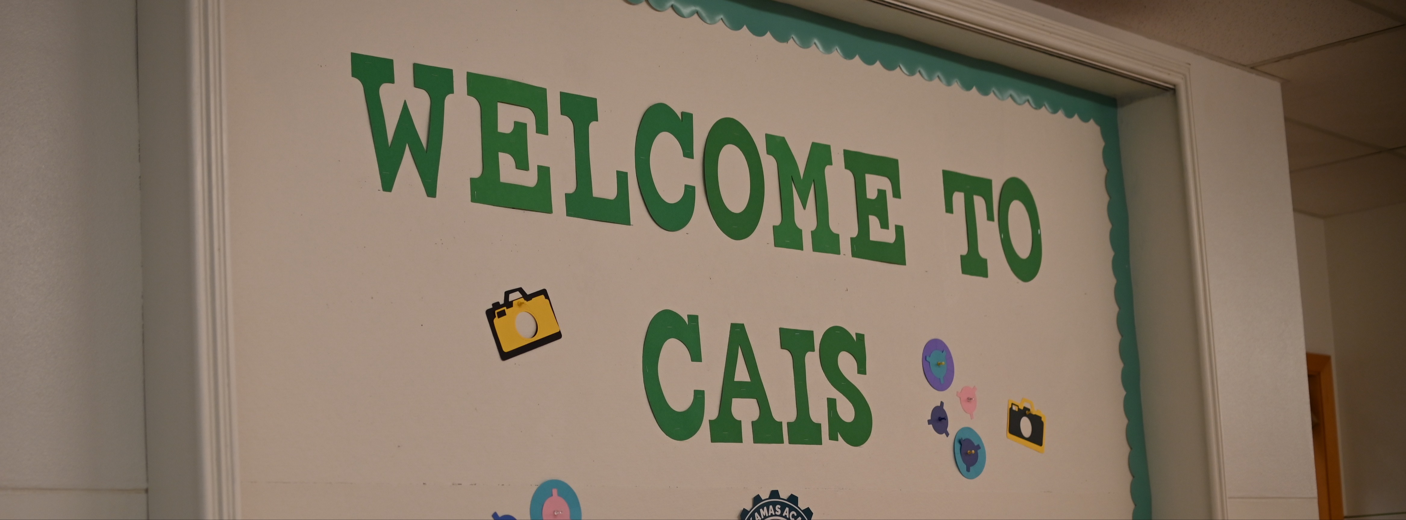 Welcome to CAIS on a hallway bulletin board