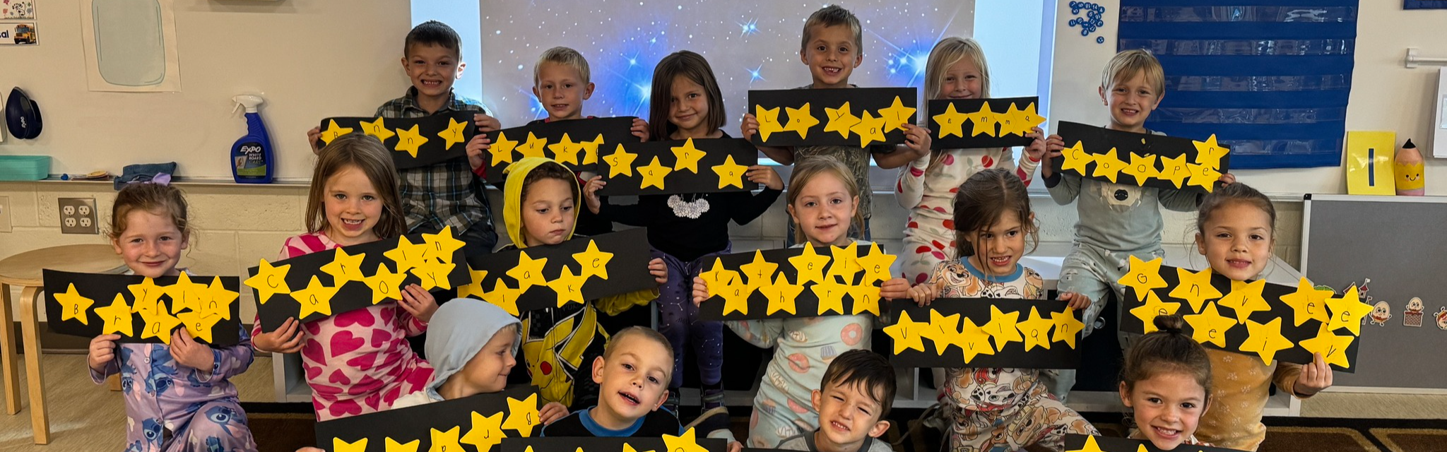 Students holding up their artwork