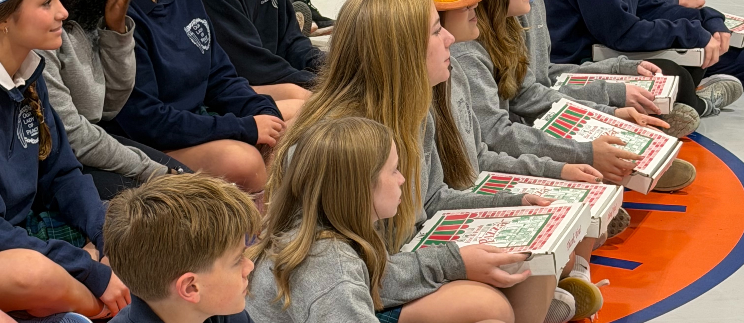 Our Eighth Graders say- Buy our famous Our Lady of Peace Pizzas!