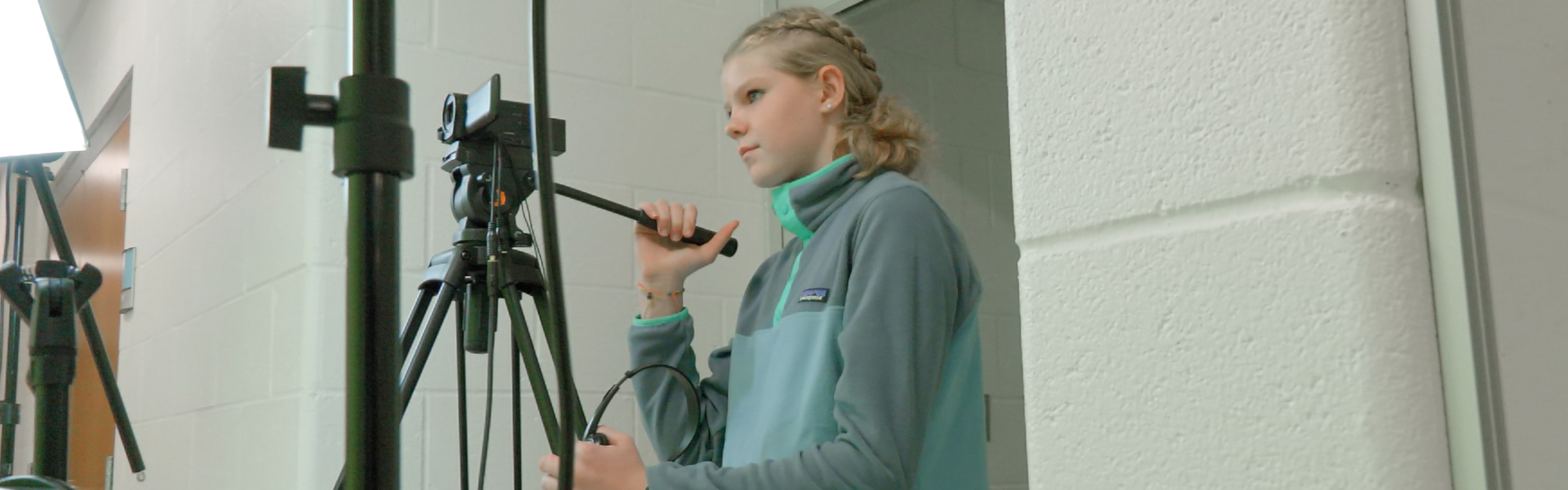 student learning to use camera in class