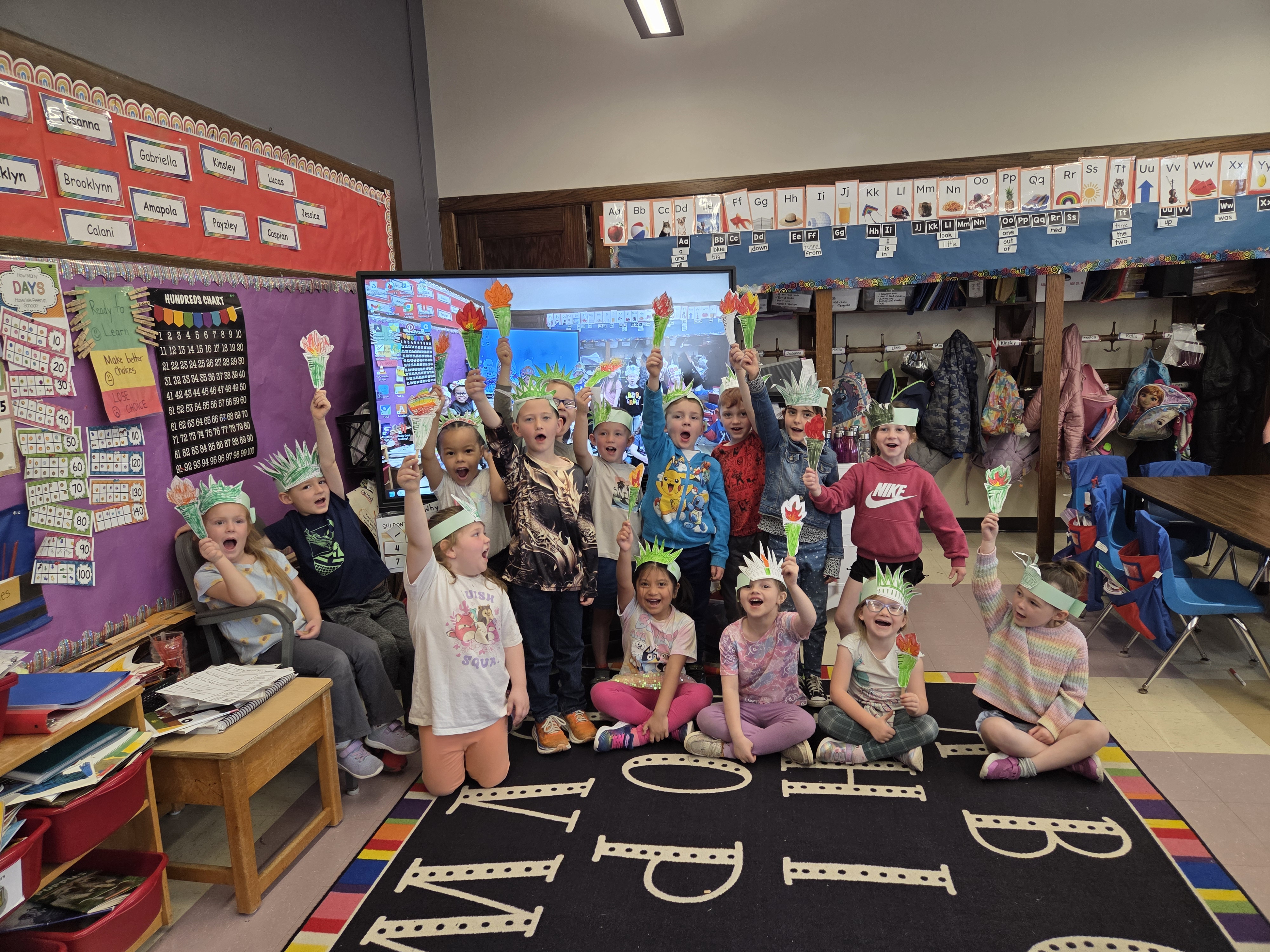 CES students pose as the Statue of Liberty