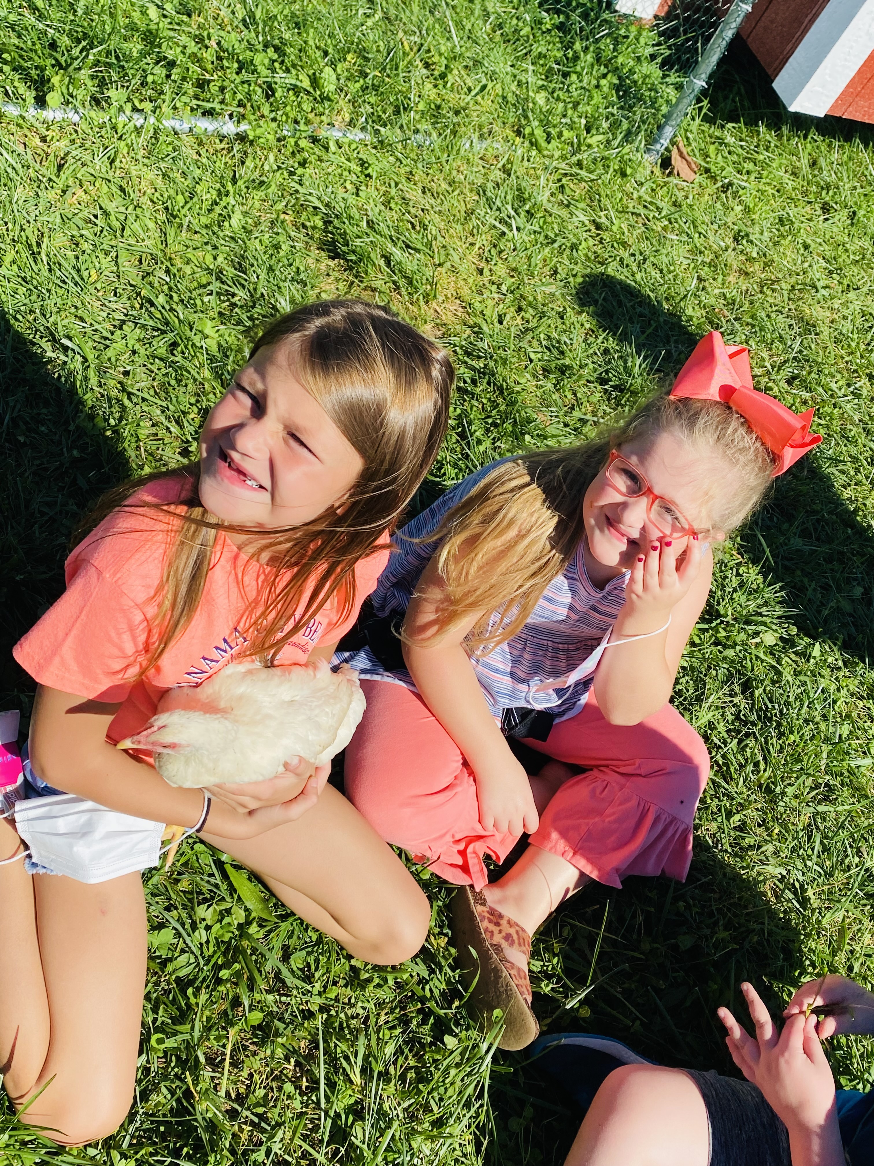 two girls with a chicken