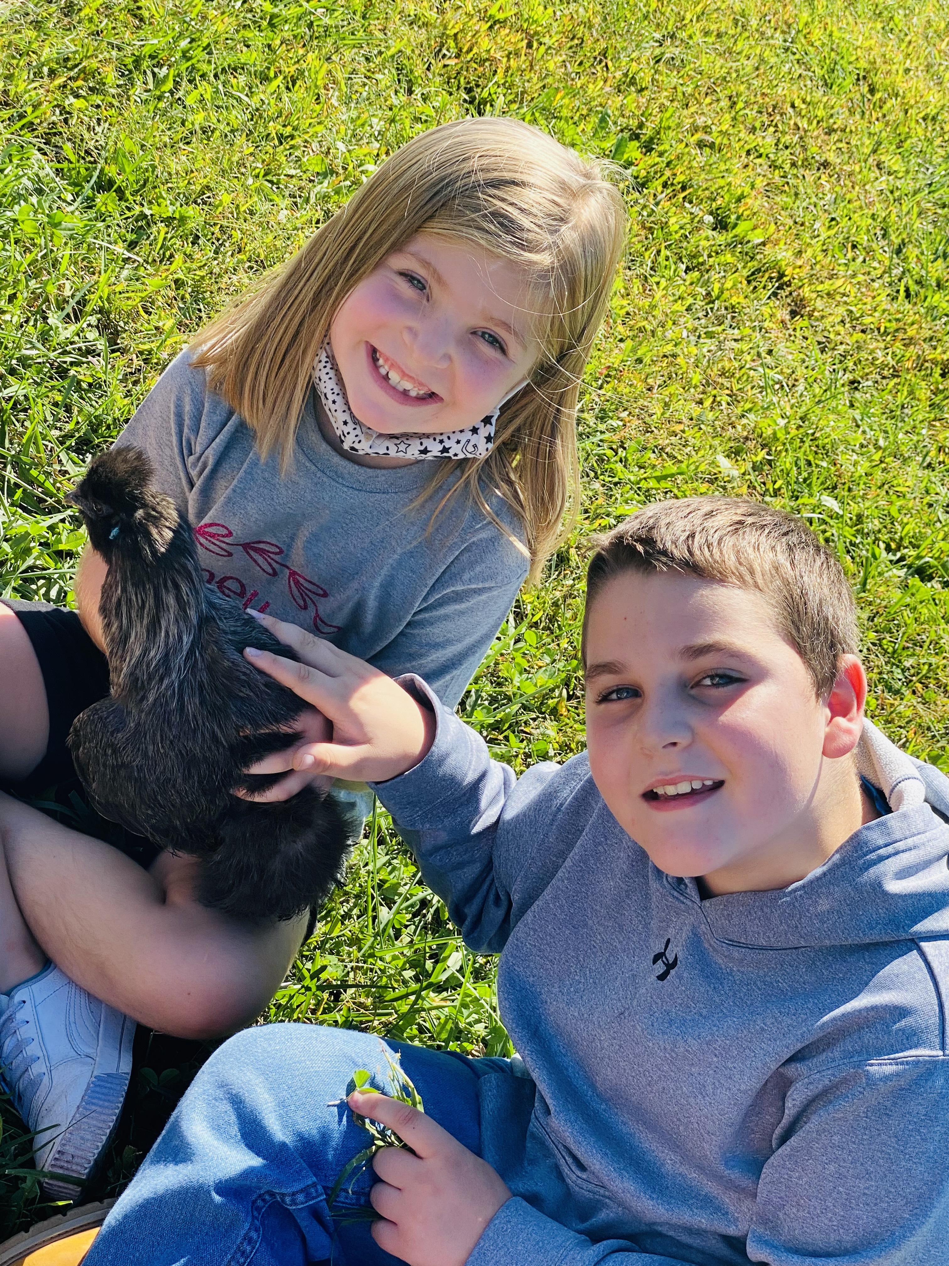two children with a chicken
