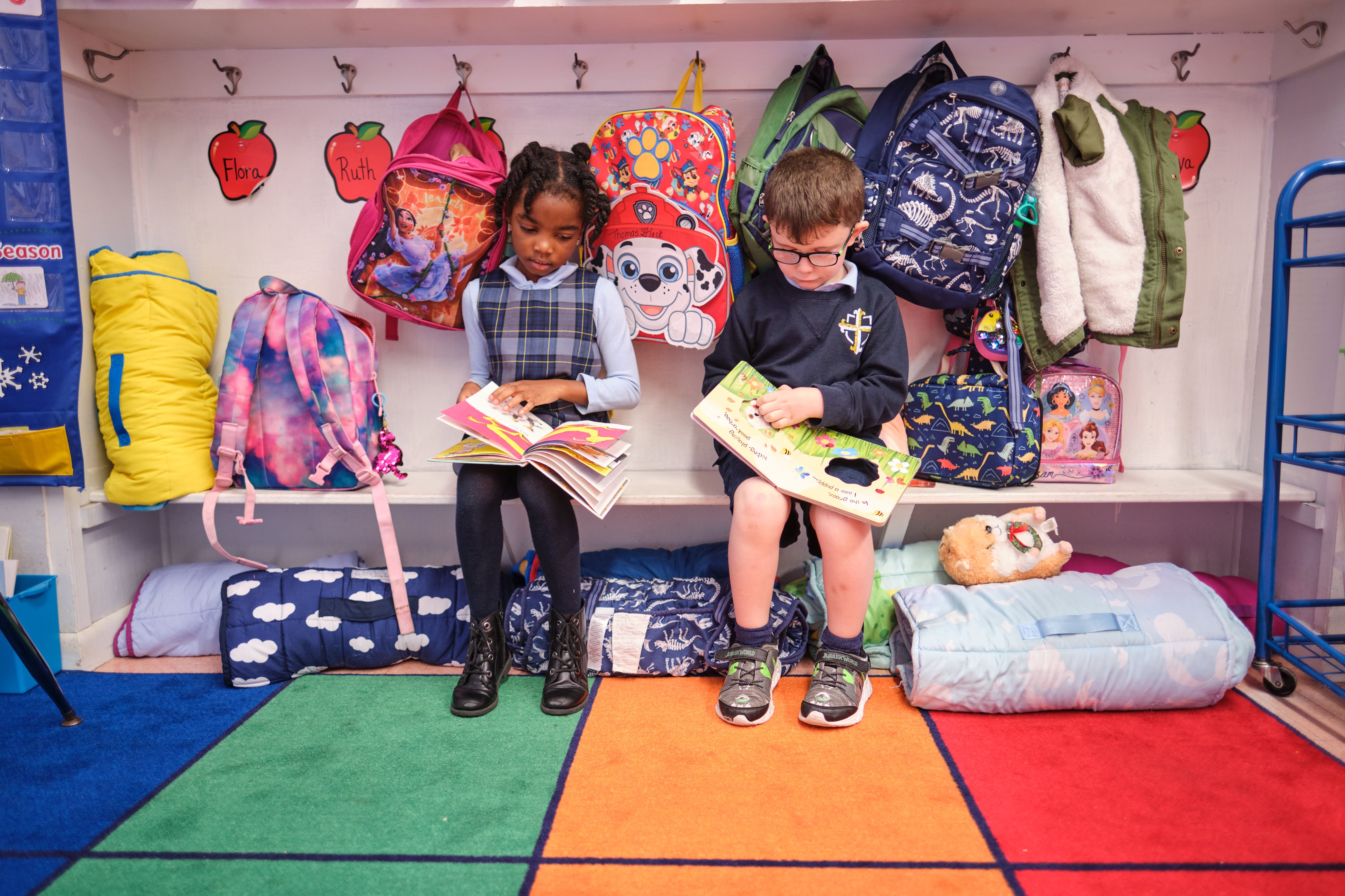 Two St. Pius V School PreK students reading
