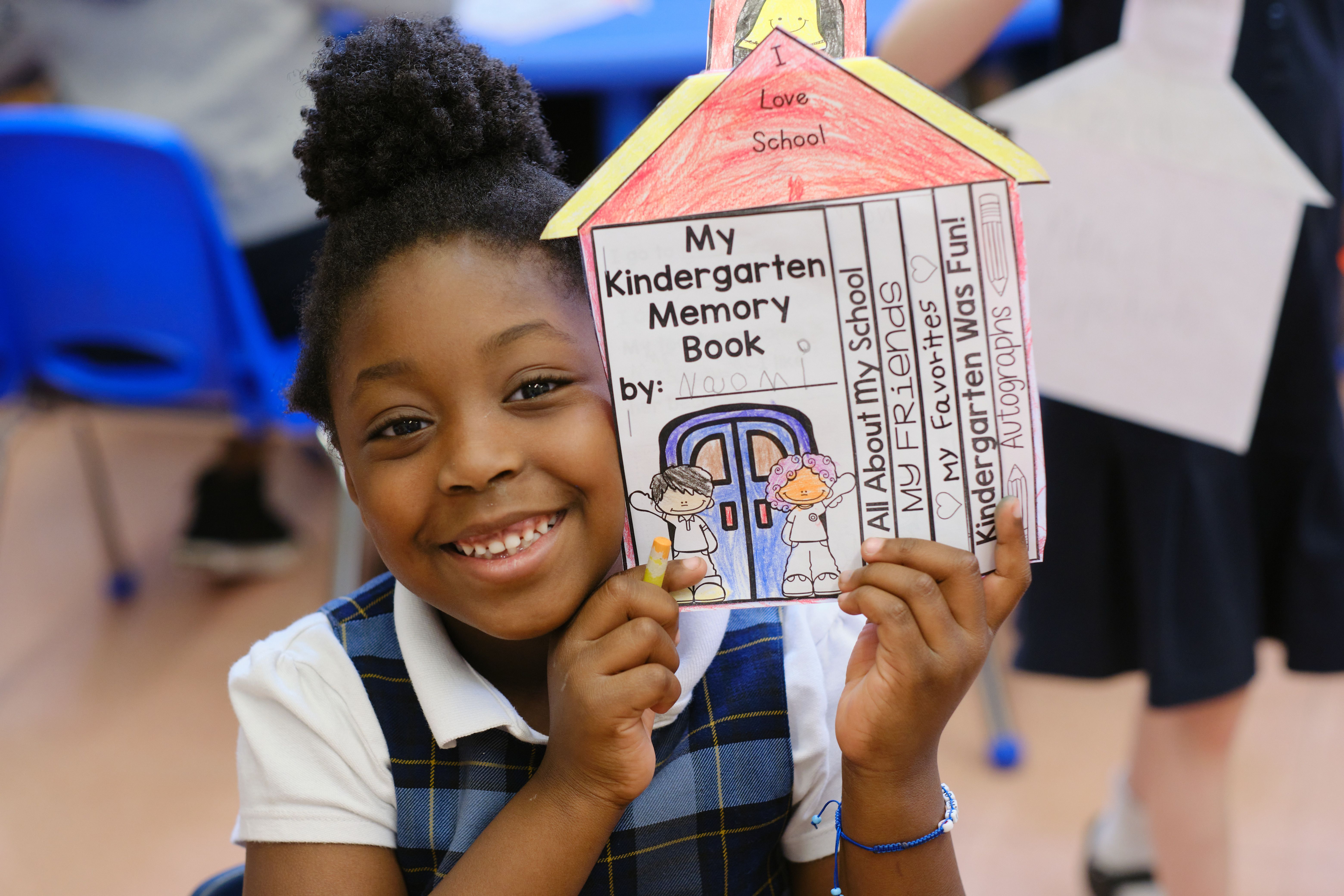 St. Pius V School kindergartener shows off her book