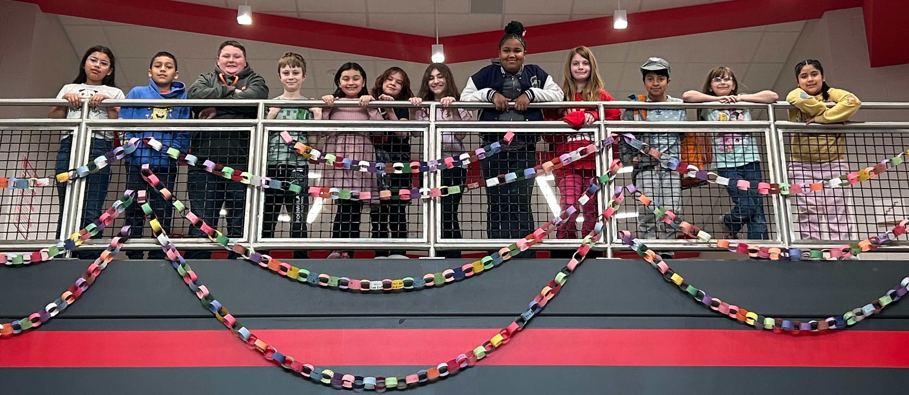 Group of students looking down from the second floor to the first floor