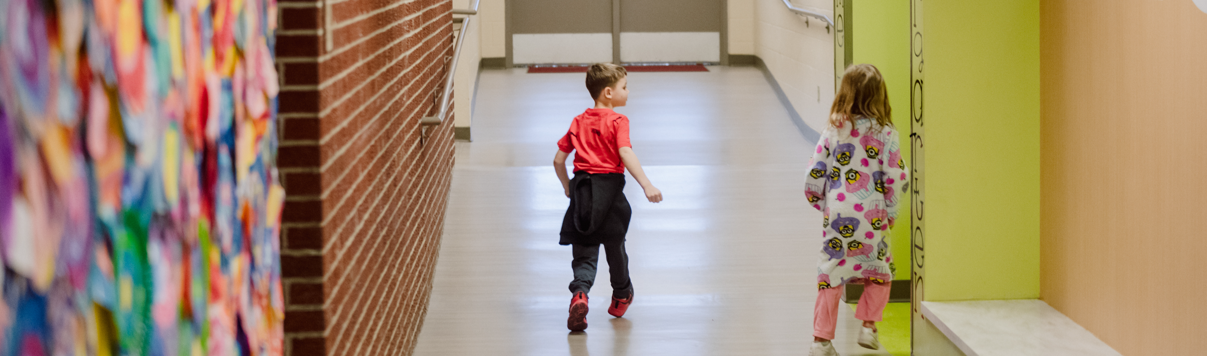 Students walking in a colorful hallway