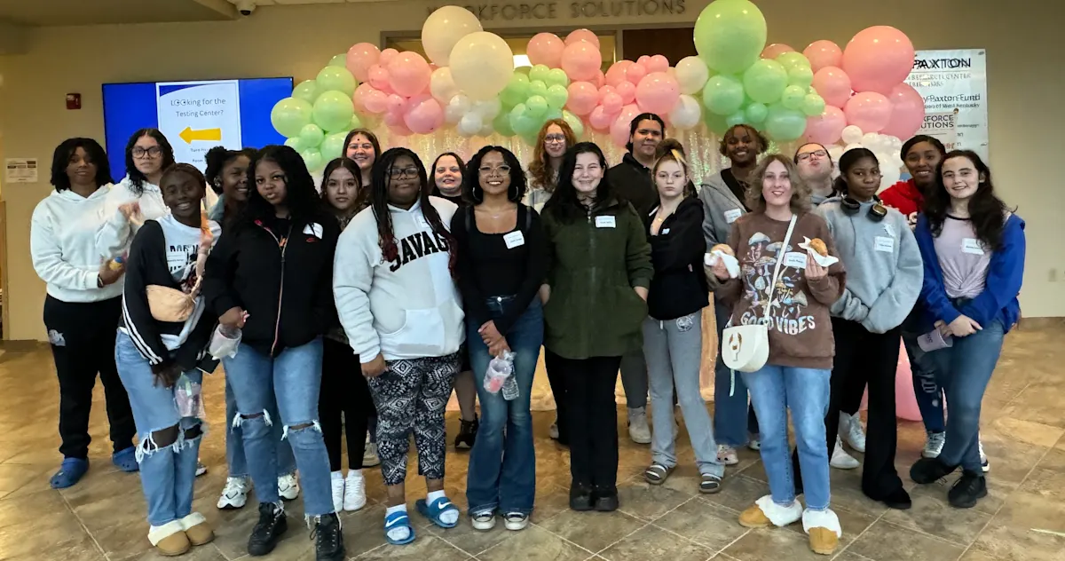 Group of students in front of balloon garland