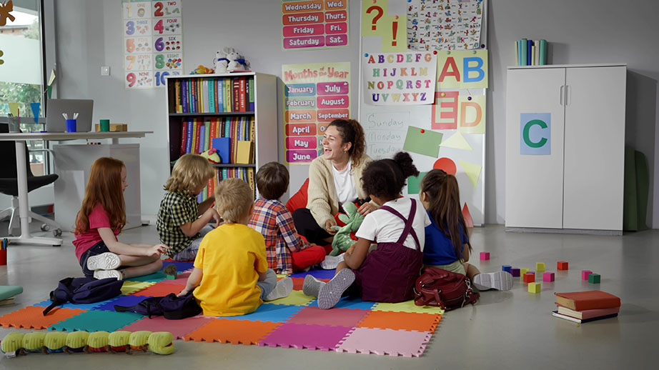 Teacher and students on colorful floor tiles for learning