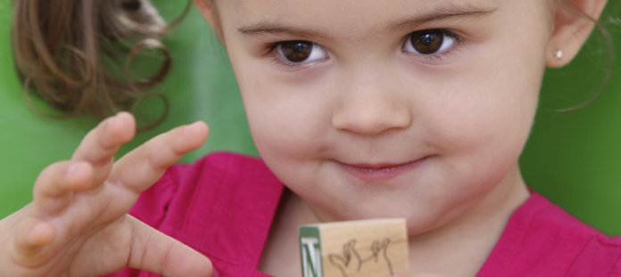Young child playing with wooden blocks