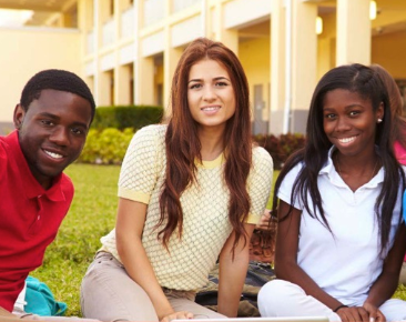 A group of three students hanging out outside