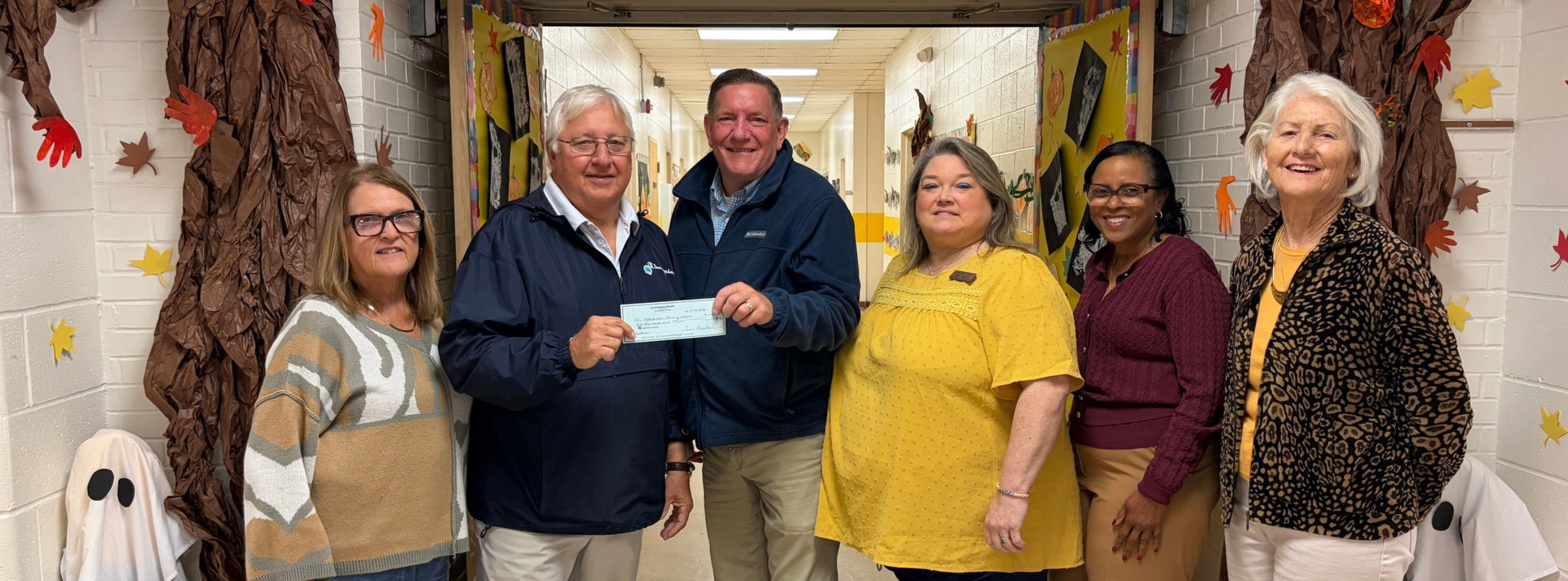 Bladenboro Rotary members present a check to BPS.