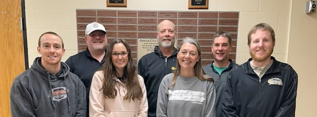 The Board of Education smiling at the camera