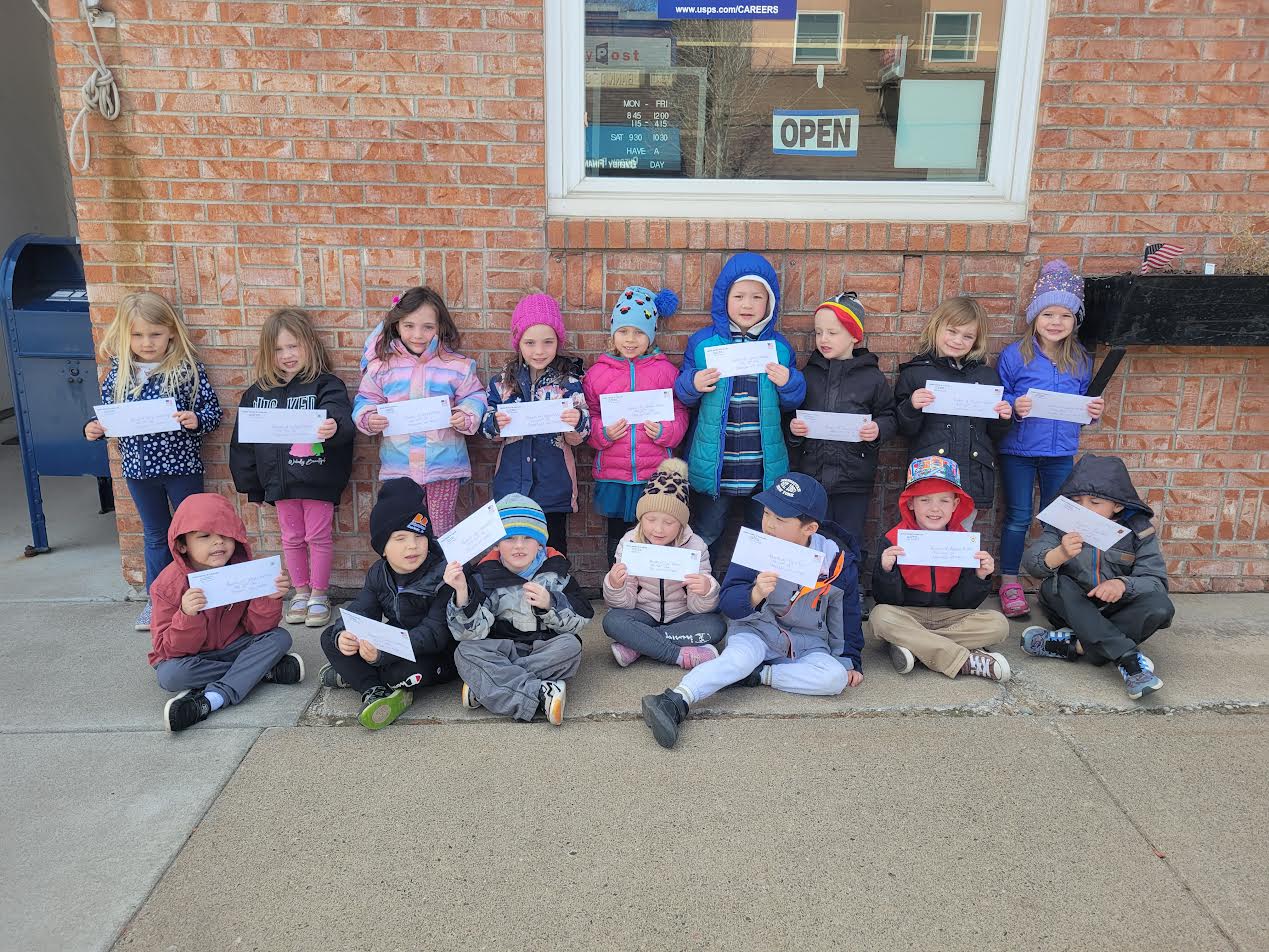 group of elementary students outside of the post office