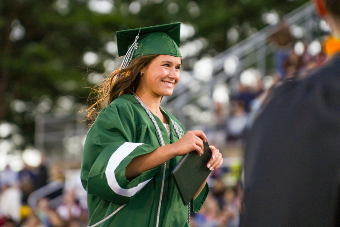Female graduate walking at commencement