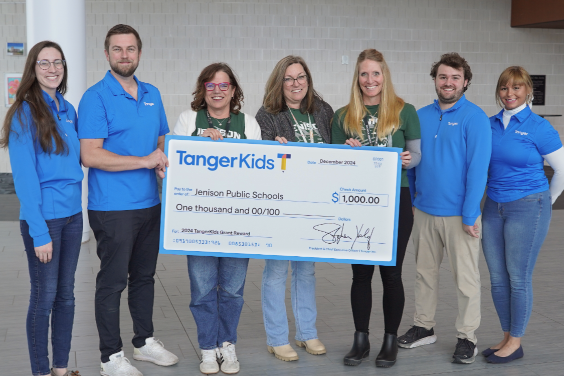 group of parent liaisons holding large check
