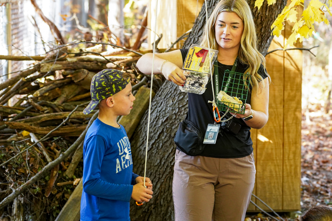 Wilderness Academy teacher showing student bird feed