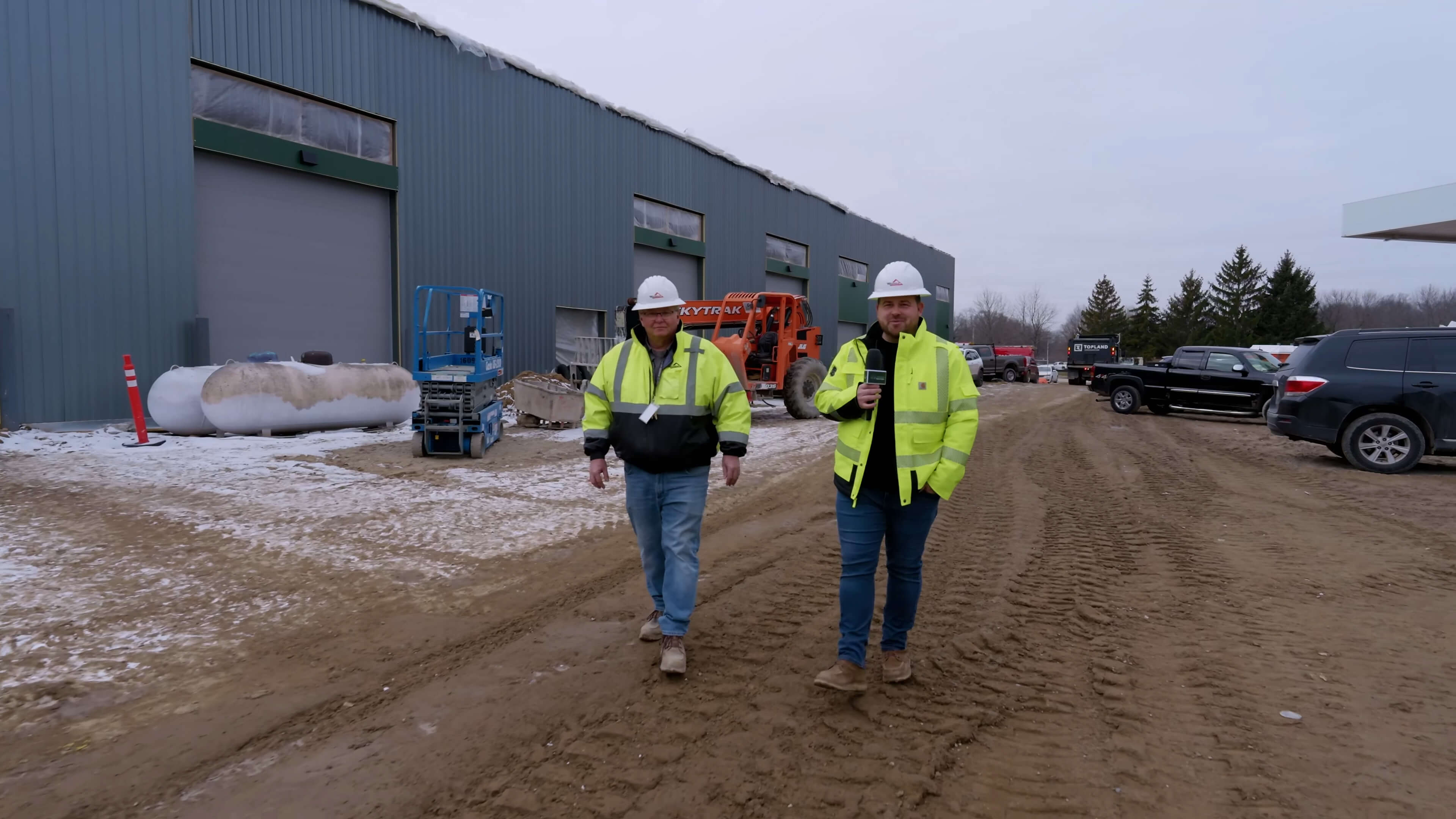Two men walking near MTC building