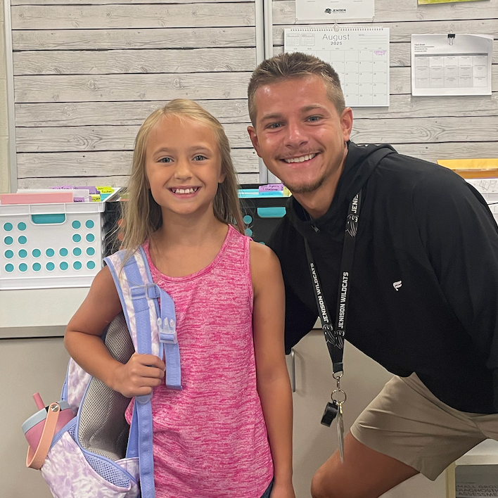 Mr. Smith with his student Mady. both are smiling for the camera. 
