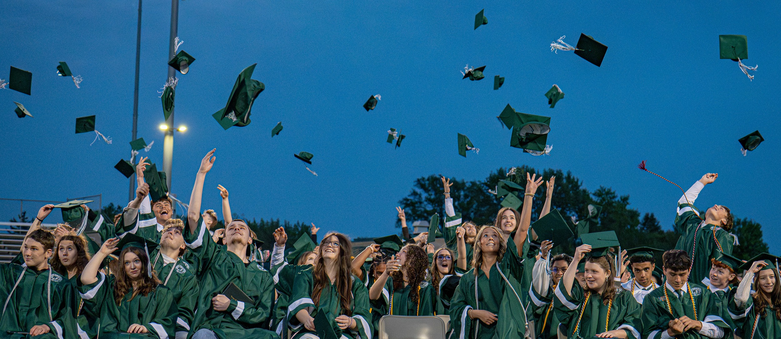 Graduates throwing their caps in the air