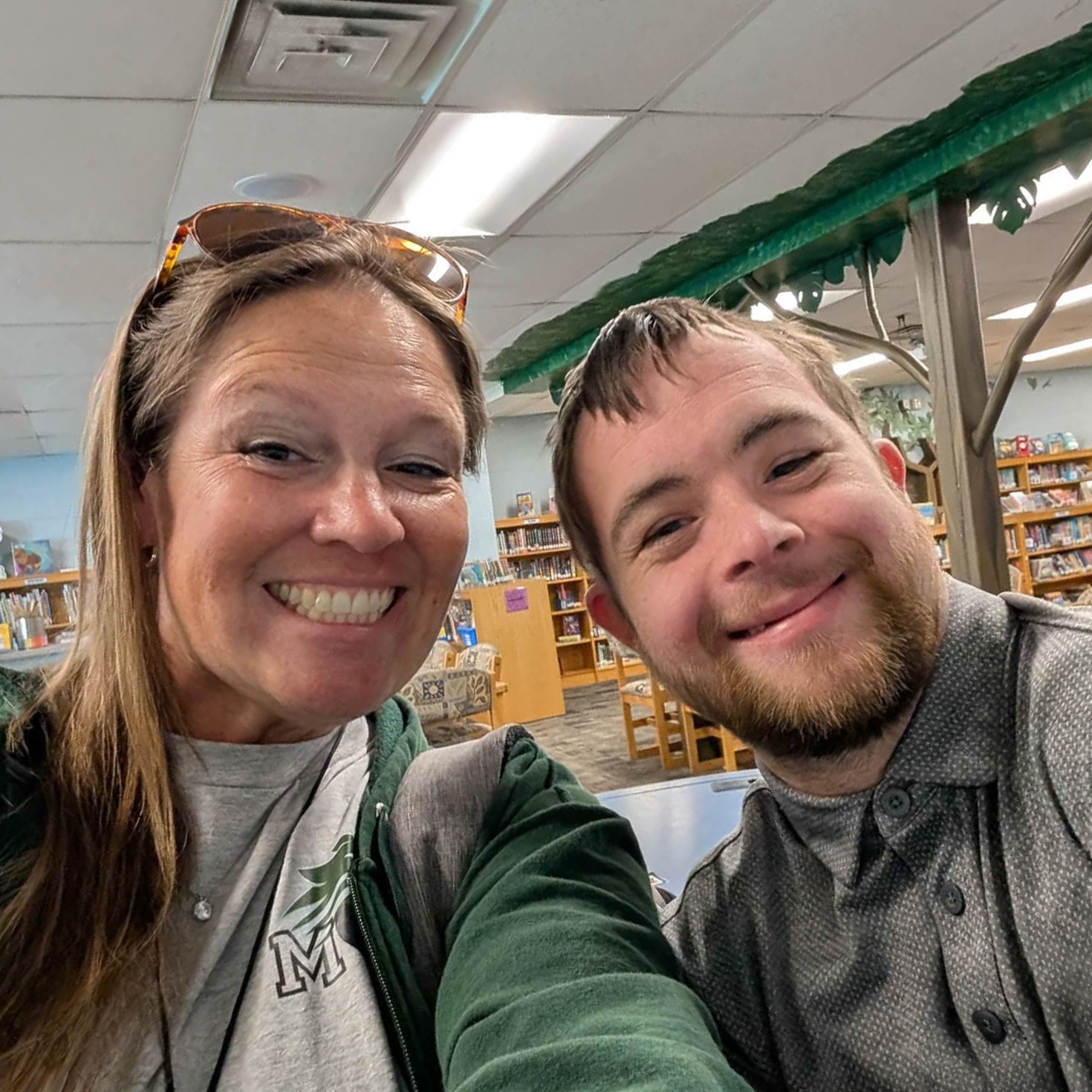 A woman named Kristie smiling with a man named Kyle, taking a selfie.