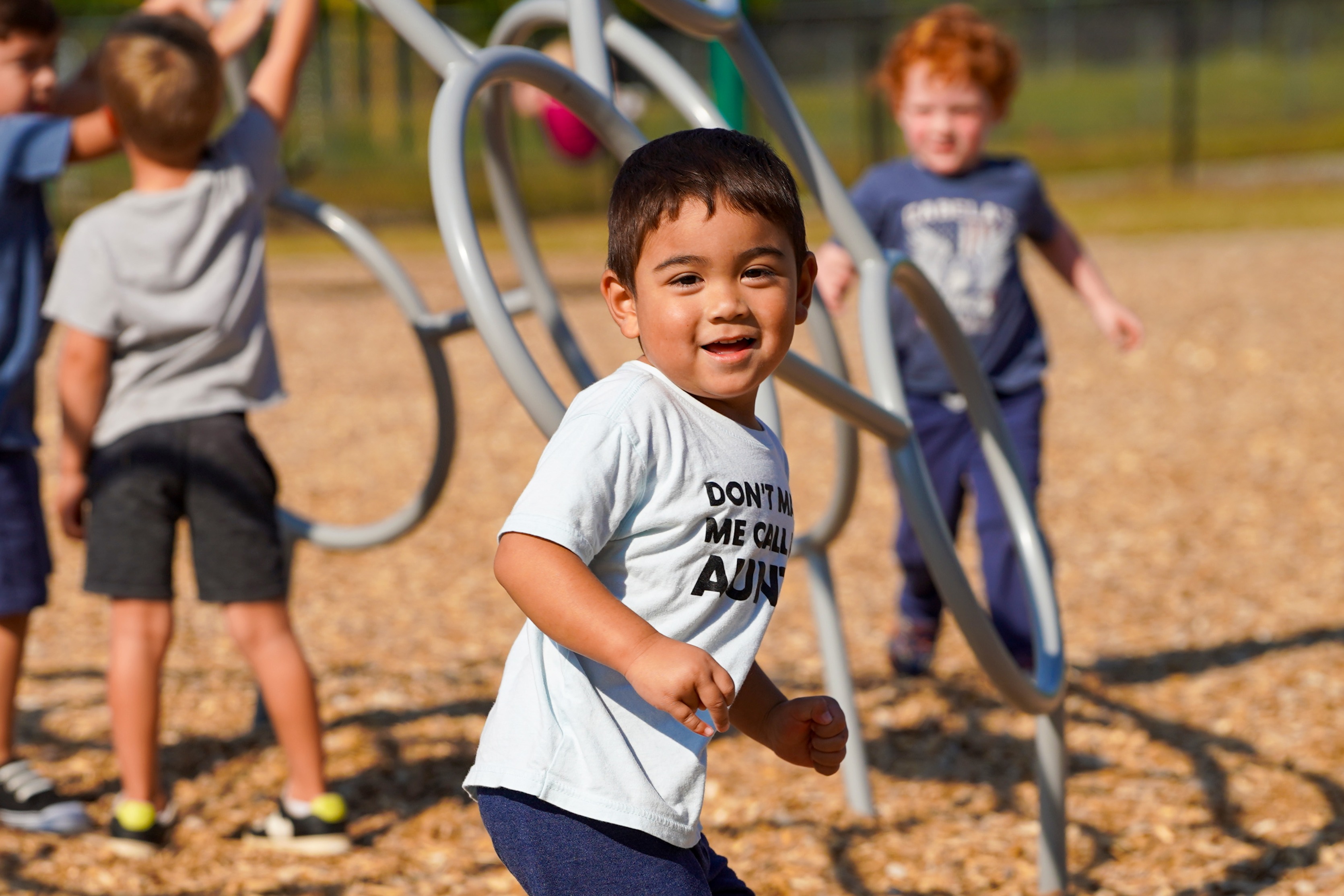 Young child at preschool playing on playground