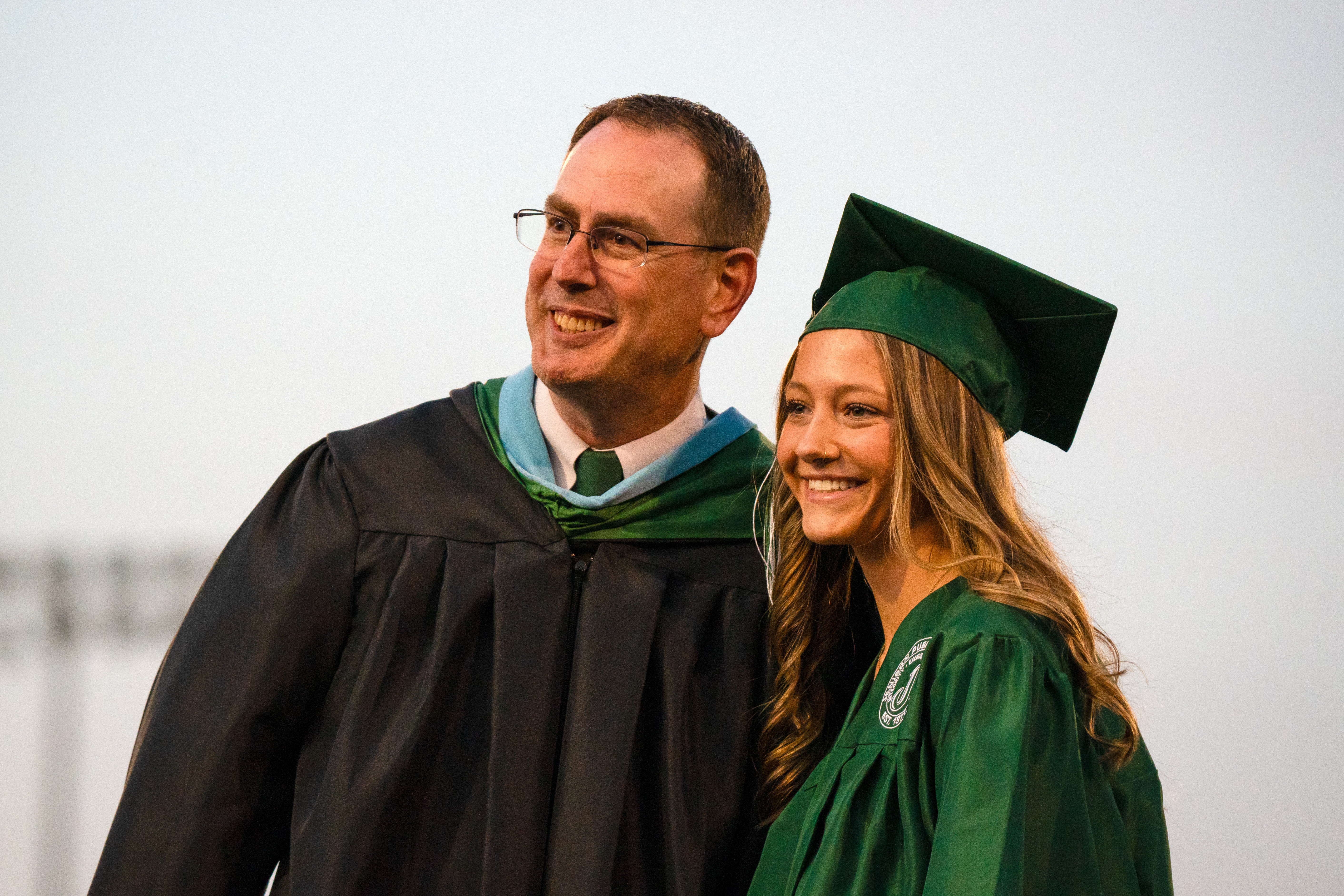 JIA student smiling with principal at graduation