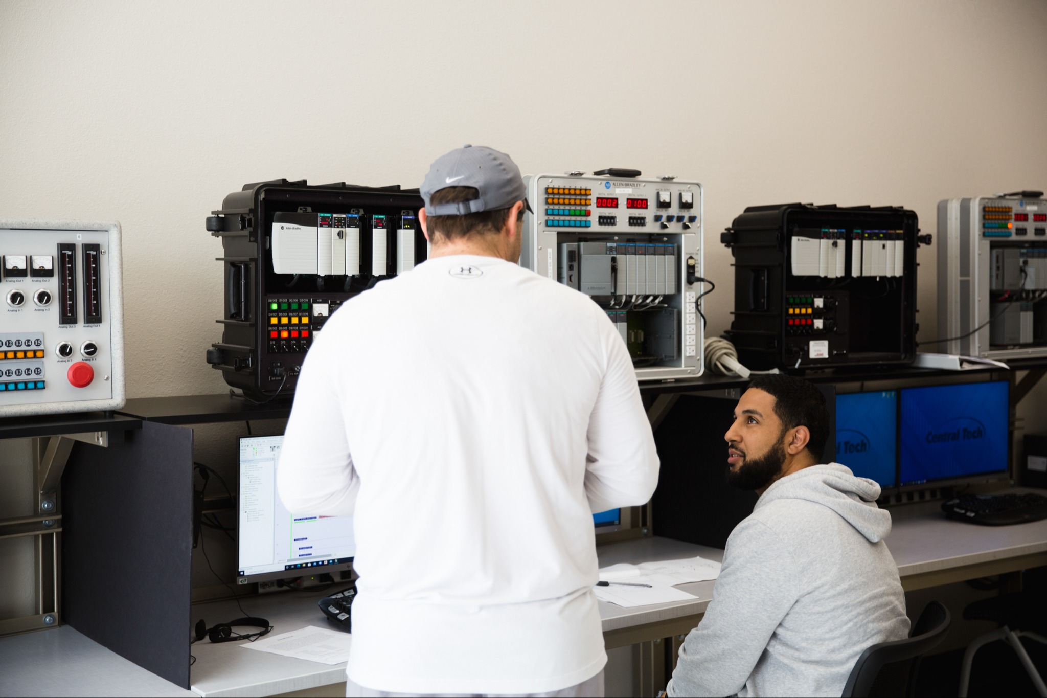 An instructor and a student sit in front of computers for Control Logic