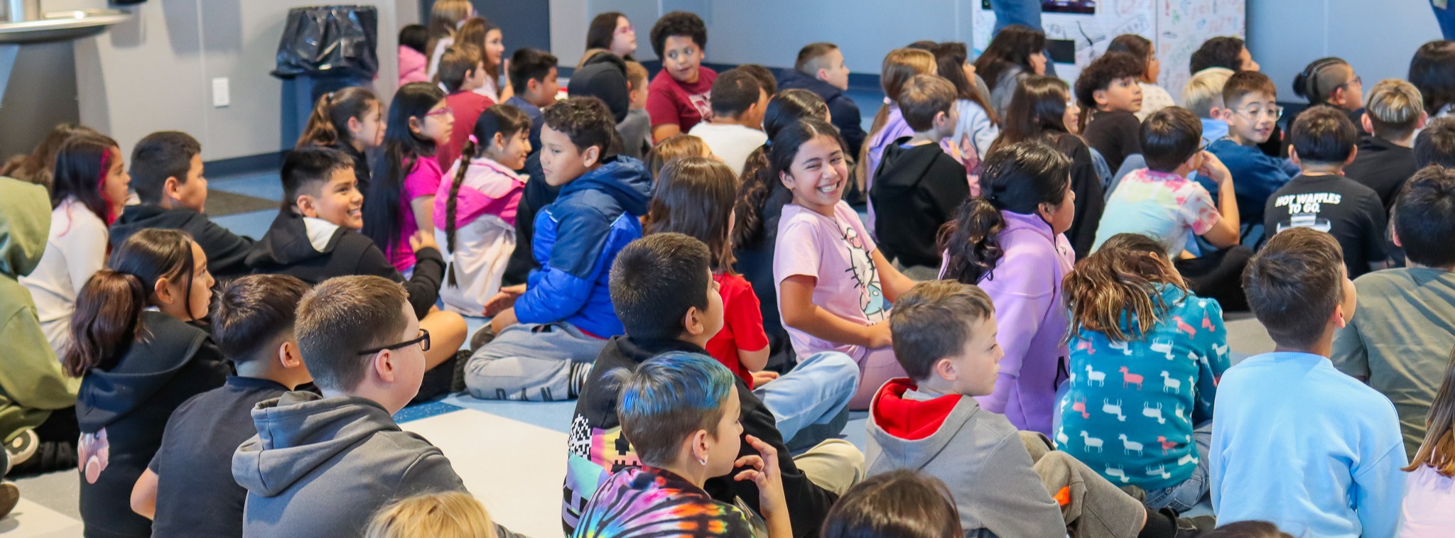Students waiting for ribbon cutting of new Book Vending Machine