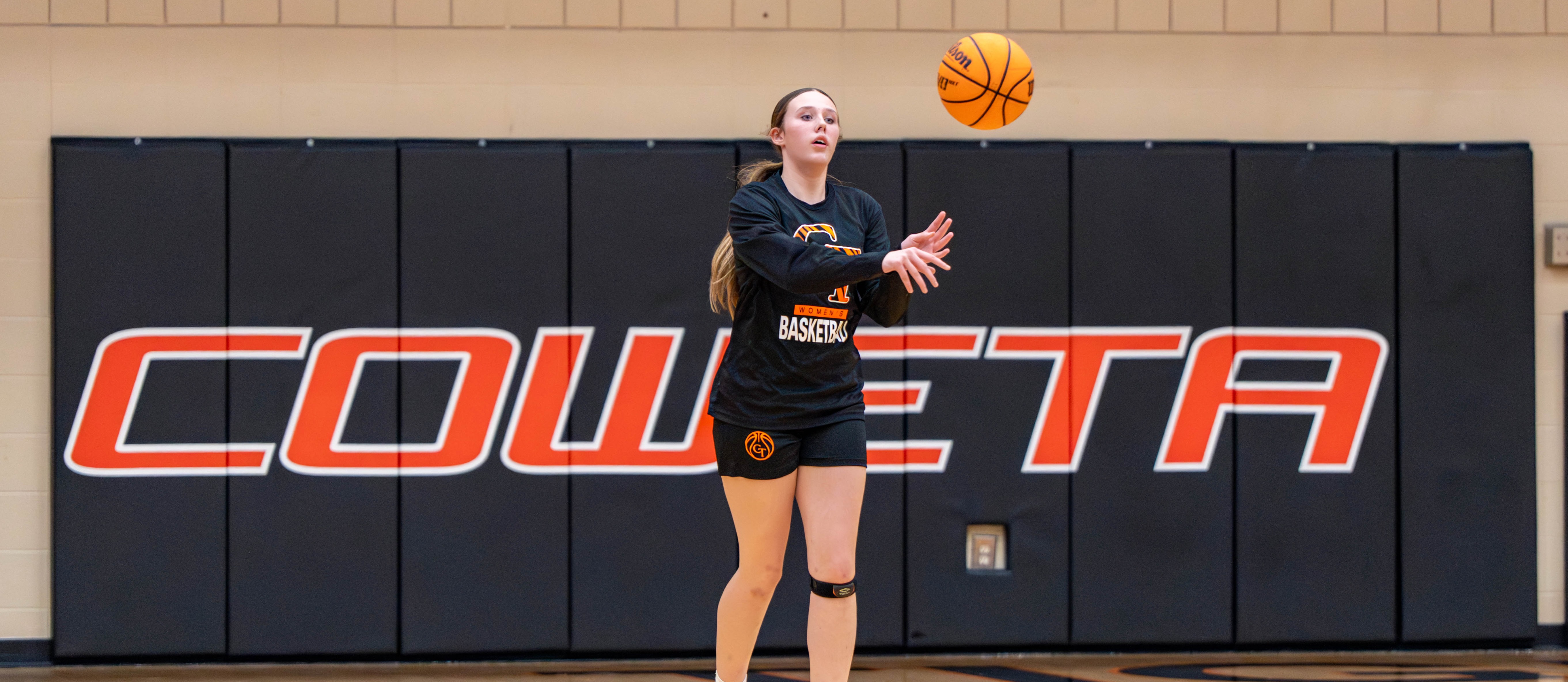 Girls playing basketball and staring at the net