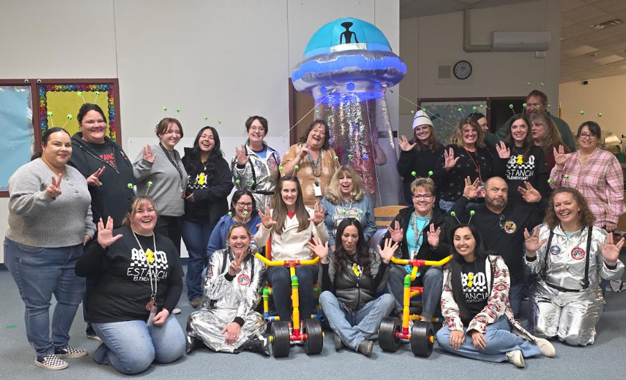 Elementary Staff posing with UFO decor