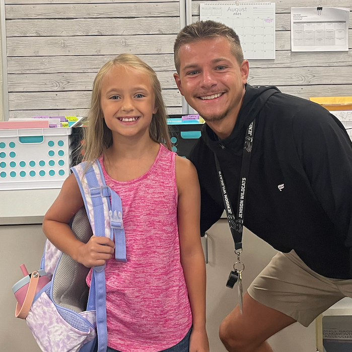 Mr. Smith with his student Mady. both are smiling for the camera. 