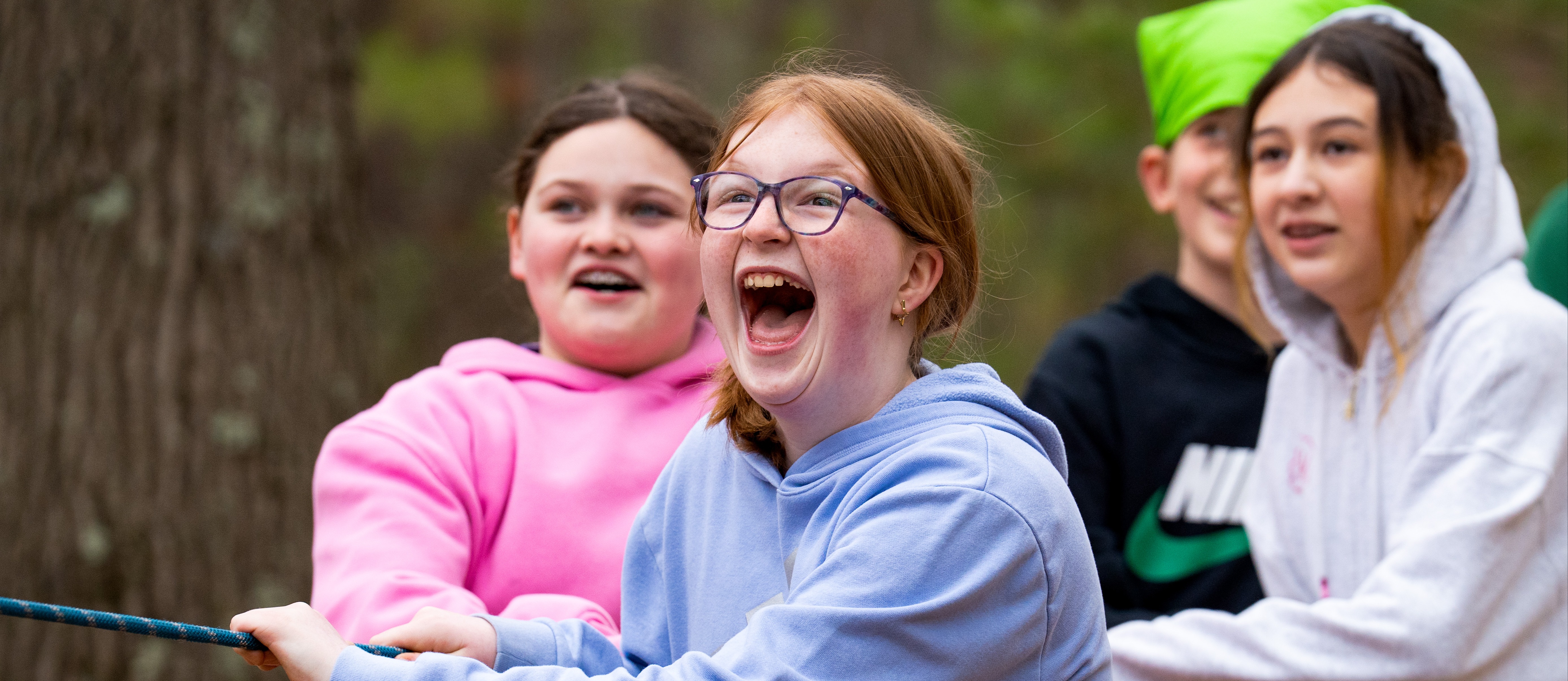 Students holding on to a rope at camp