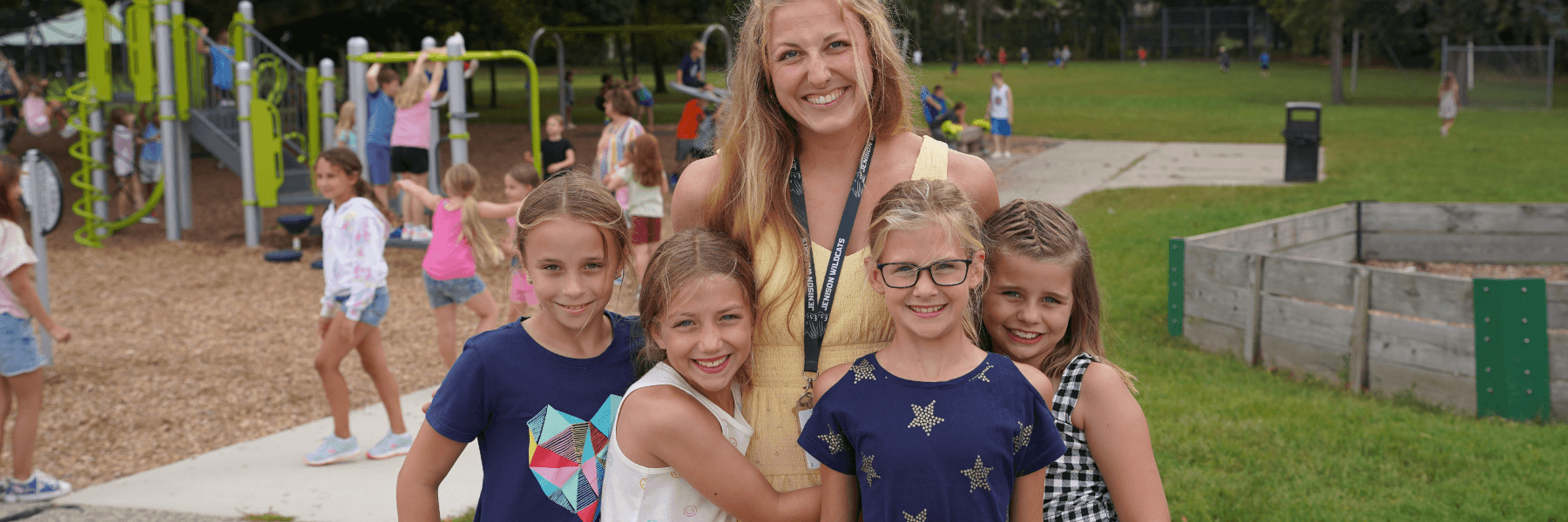 teacher and group of kids smiling